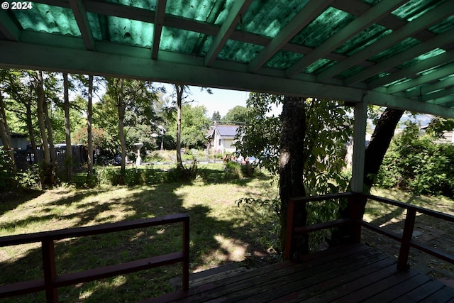 wooden terrace featuring a lawn