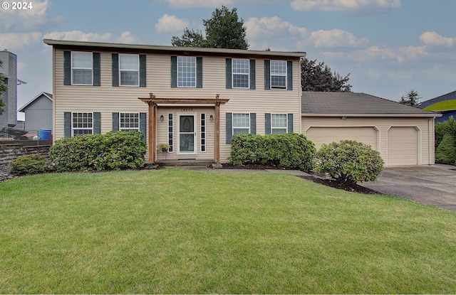 colonial house with a garage and a front yard