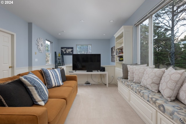 carpeted living room with a healthy amount of sunlight