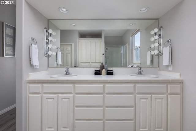 bathroom featuring hardwood / wood-style floors, an enclosed shower, and vanity