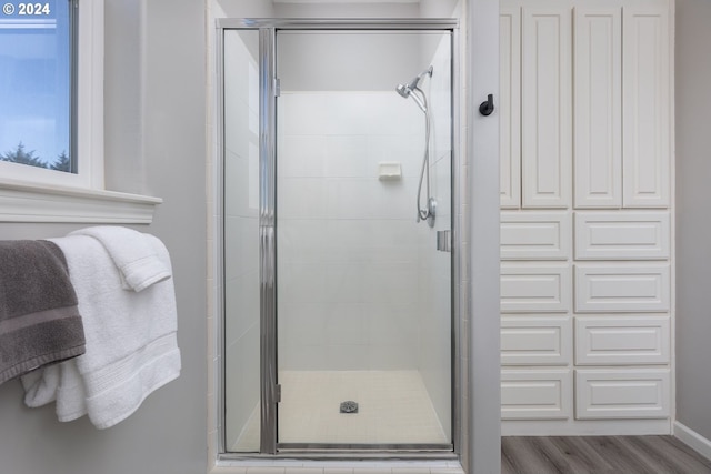 bathroom featuring walk in shower and hardwood / wood-style floors