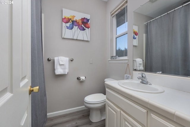 bathroom with vanity, hardwood / wood-style flooring, and toilet