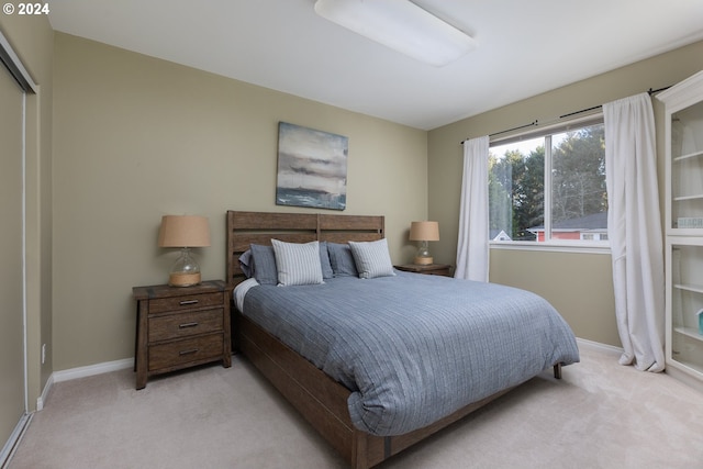 bedroom featuring light carpet