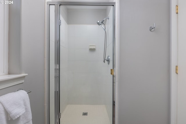 bathroom featuring a shower with door