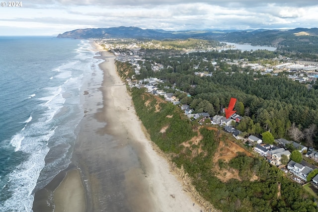 drone / aerial view featuring a beach view and a water and mountain view