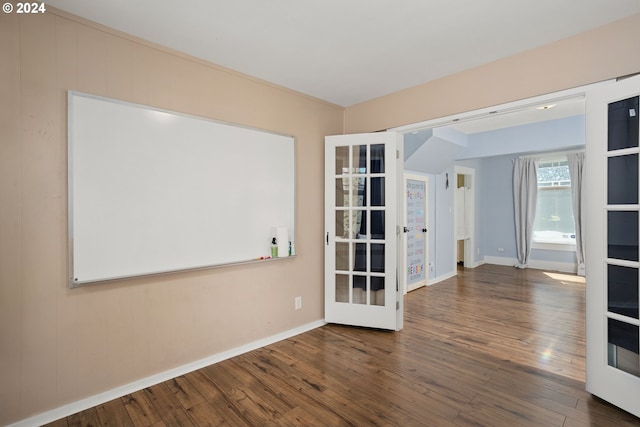 spare room featuring dark hardwood / wood-style floors and french doors