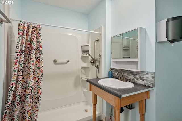 bathroom with sink, tasteful backsplash, and curtained shower