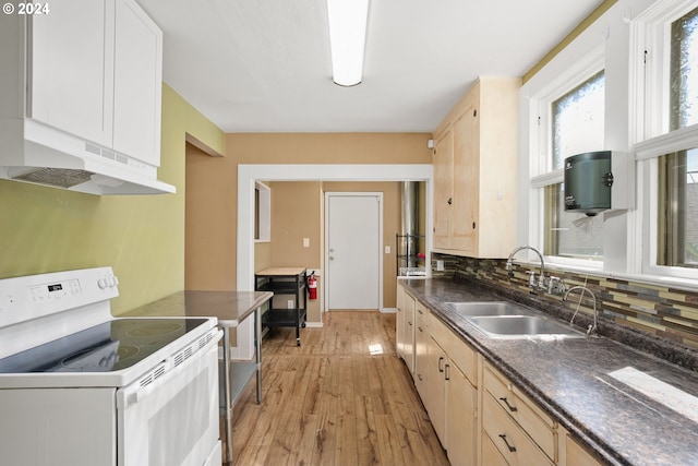 kitchen featuring light wood-type flooring, sink, decorative backsplash, light brown cabinets, and white range with electric stovetop