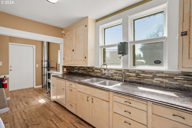 kitchen with light hardwood / wood-style flooring, light brown cabinets, tasteful backsplash, and sink