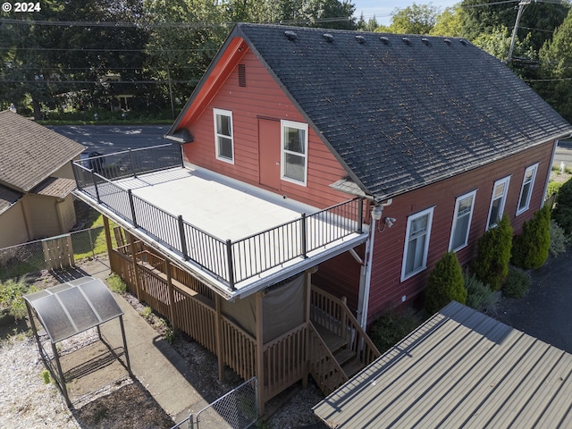 rear view of house featuring a wooden deck