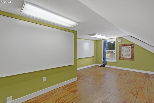 bonus room with light hardwood / wood-style flooring and lofted ceiling