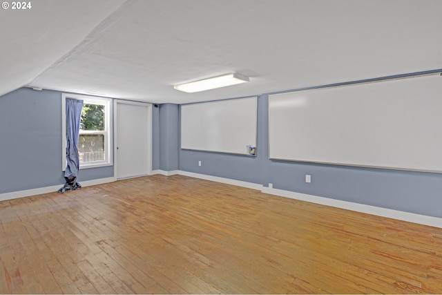 interior space featuring light wood-type flooring and lofted ceiling