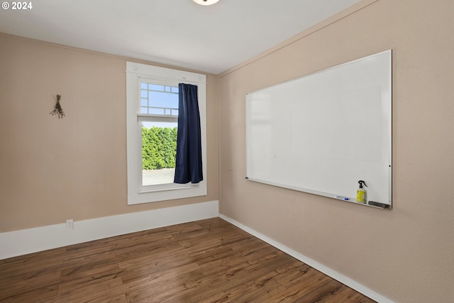 unfurnished room featuring ornamental molding and hardwood / wood-style flooring