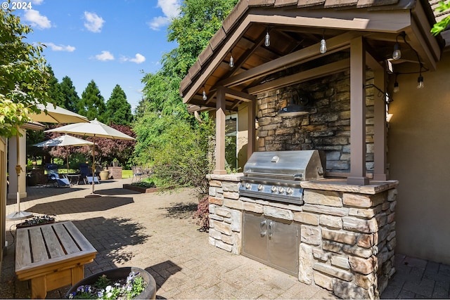 view of patio with grilling area and an outdoor kitchen