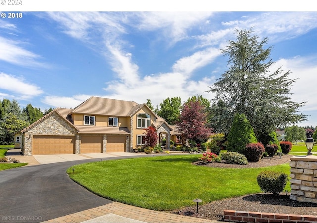 view of front facade with a garage and a front lawn