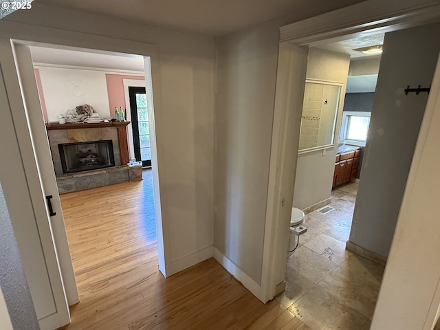 hallway with light hardwood / wood-style floors