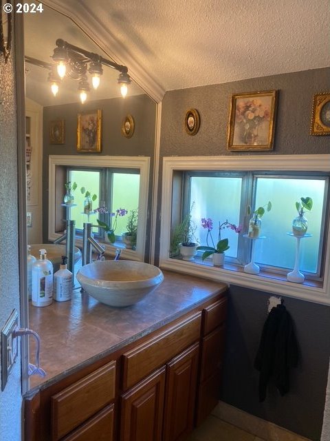 bathroom with vanity and a textured ceiling