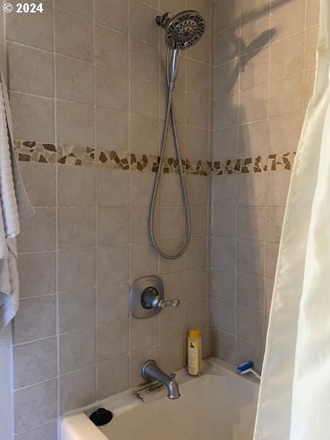 bathroom with shower / bath combination with curtain