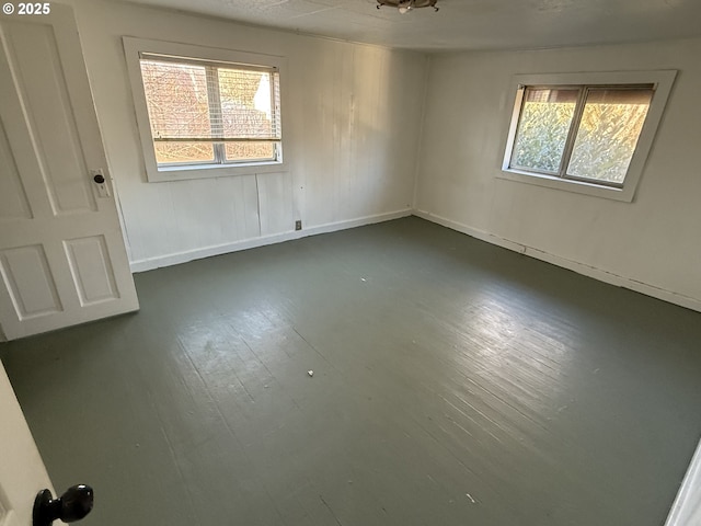 unfurnished room with a healthy amount of sunlight and dark hardwood / wood-style floors