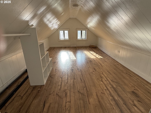 additional living space featuring dark hardwood / wood-style floors and vaulted ceiling