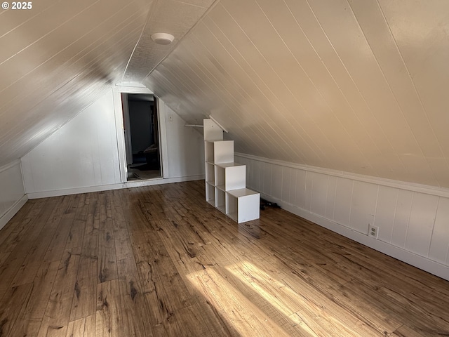 bonus room featuring wood-type flooring and vaulted ceiling