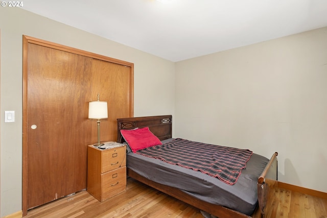 bedroom featuring light hardwood / wood-style floors and a closet