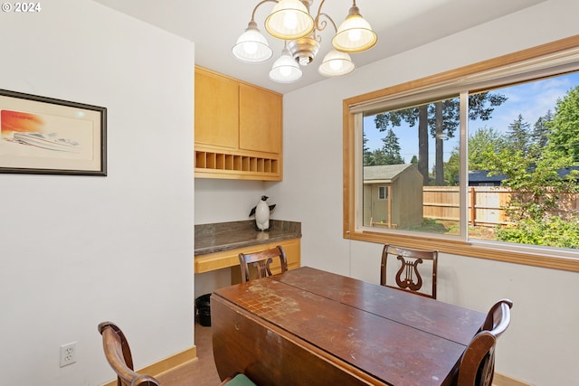 carpeted dining space with an inviting chandelier