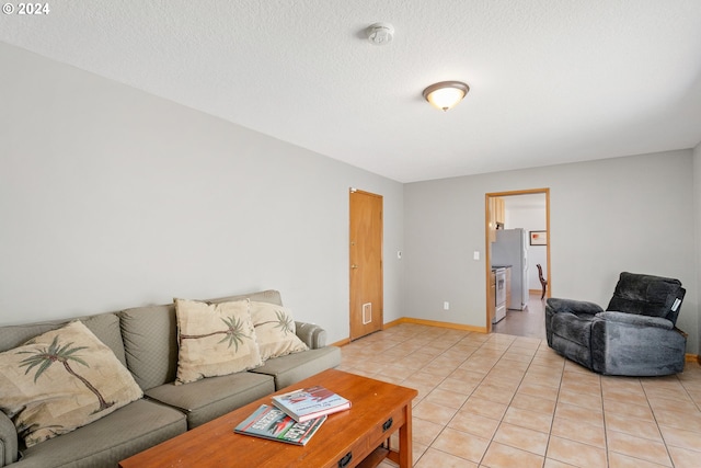 living room with light tile patterned floors and a textured ceiling