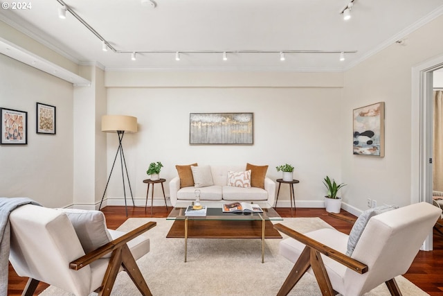 living room with track lighting, hardwood / wood-style floors, and ornamental molding