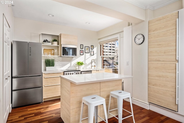 kitchen featuring a breakfast bar, dark hardwood / wood-style floors, a kitchen island, appliances with stainless steel finishes, and light brown cabinetry