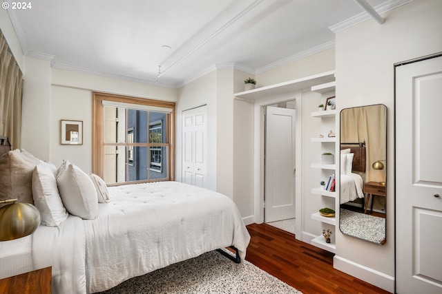 bedroom with a closet, crown molding, and dark wood-type flooring