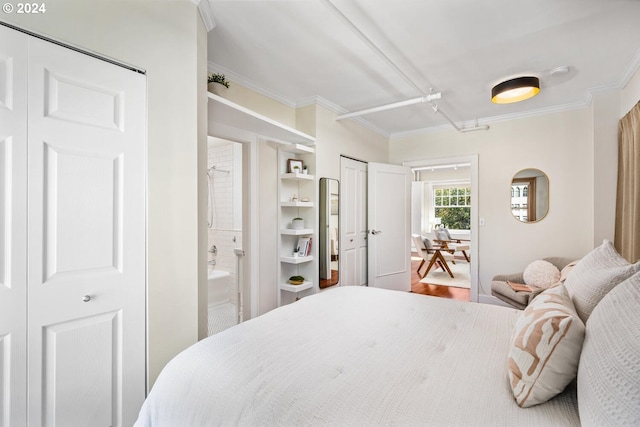 bedroom with hardwood / wood-style flooring and crown molding