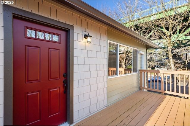 view of exterior entry featuring a deck