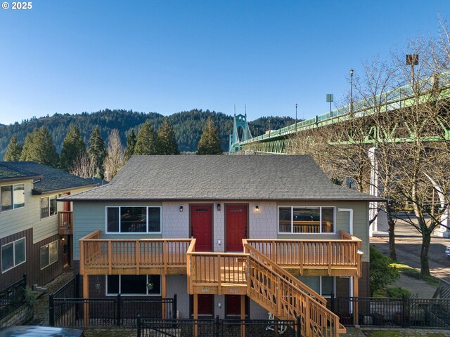 view of front of property with a deck with mountain view