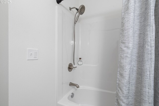 bathroom featuring shower / bathtub combination with curtain