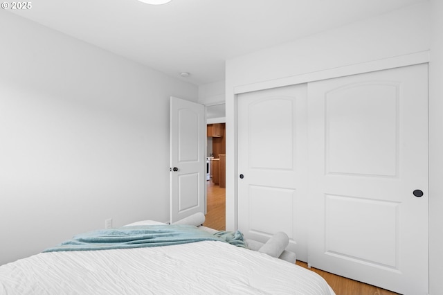 bedroom with a closet and light hardwood / wood-style floors