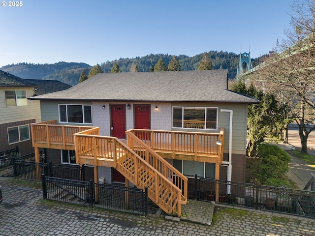 view of front of house featuring a deck with mountain view