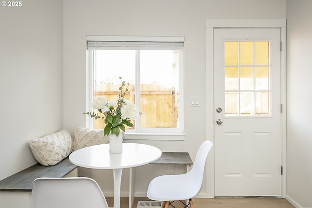 dining room with a wealth of natural light, light hardwood / wood-style floors, and breakfast area