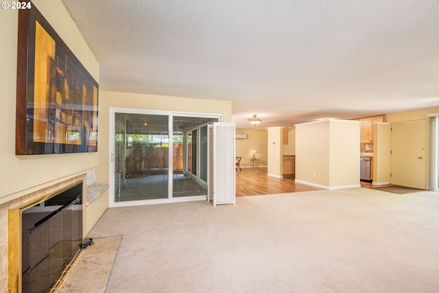 living area with a premium fireplace, baseboards, light colored carpet, and a textured ceiling