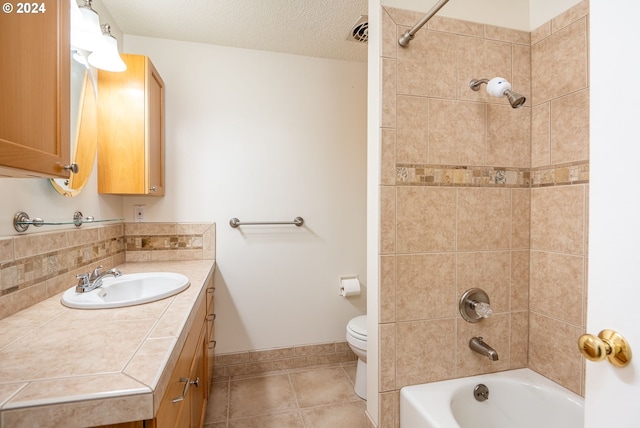 full bath with vanity, a textured ceiling, tile patterned flooring, shower / washtub combination, and toilet