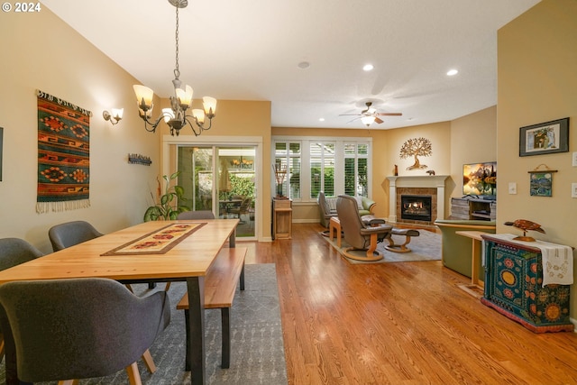 dining room featuring hardwood / wood-style floors and ceiling fan with notable chandelier