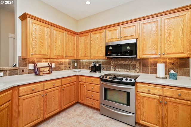 kitchen with stainless steel appliances and decorative backsplash