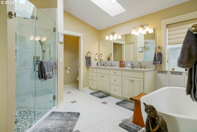 bathroom featuring vanity, tile patterned flooring, shower with separate bathtub, and vaulted ceiling with skylight