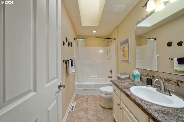 full bathroom featuring toilet, a skylight, vanity, shower / bathtub combination with curtain, and backsplash