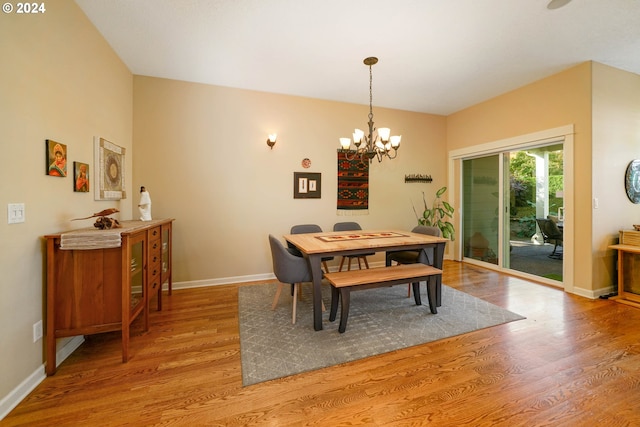 dining area with an inviting chandelier and light hardwood / wood-style floors