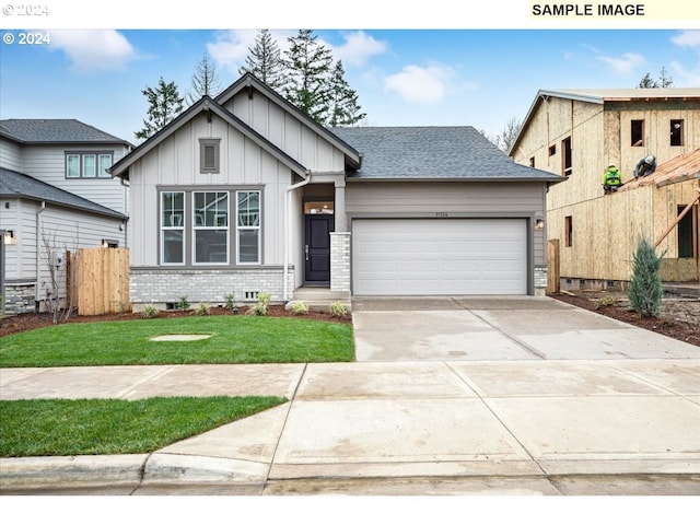 view of front of property with a front lawn and a garage