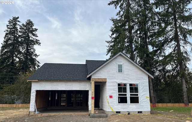 unfinished property featuring a garage