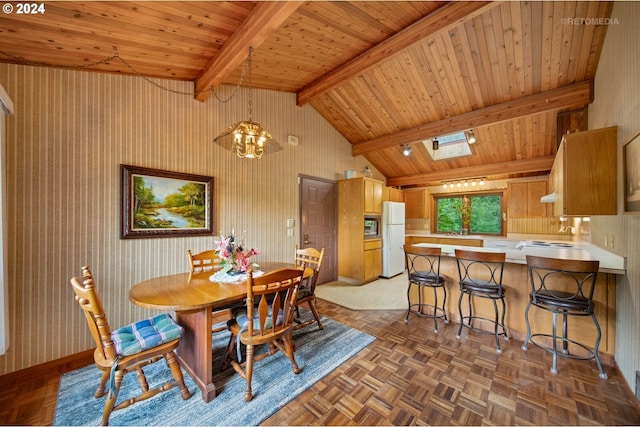 dining area featuring dark parquet flooring and lofted ceiling with skylight