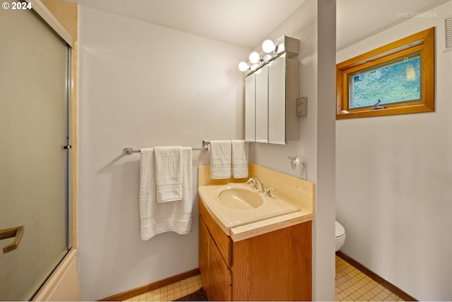 full bathroom with toilet, vanity, and shower / bath combination with glass door