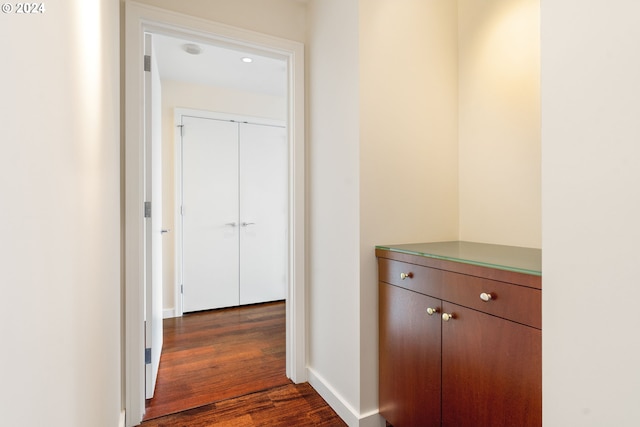 corridor featuring dark hardwood / wood-style flooring